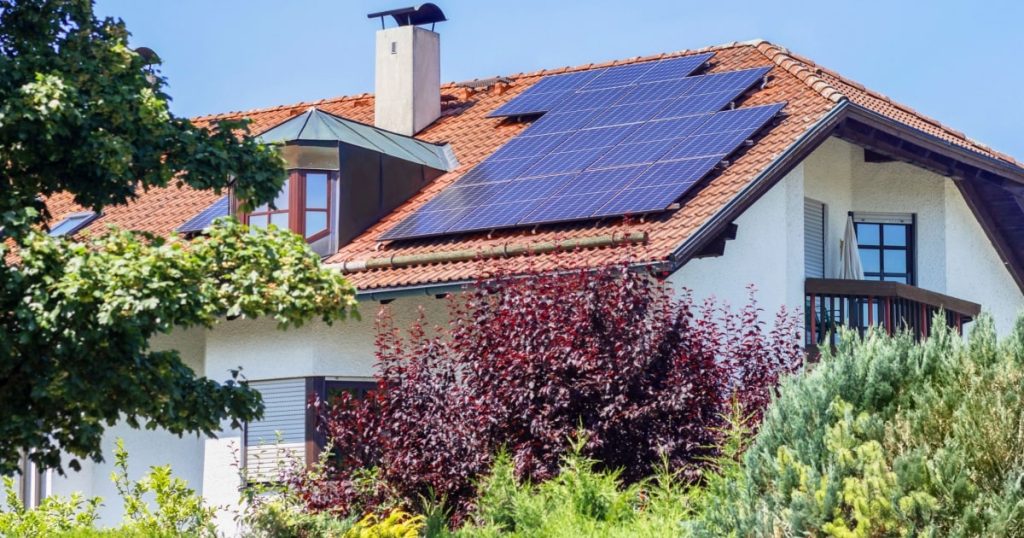 Vue extérieure d'une maison avec des panneaux solaires sur la toiture